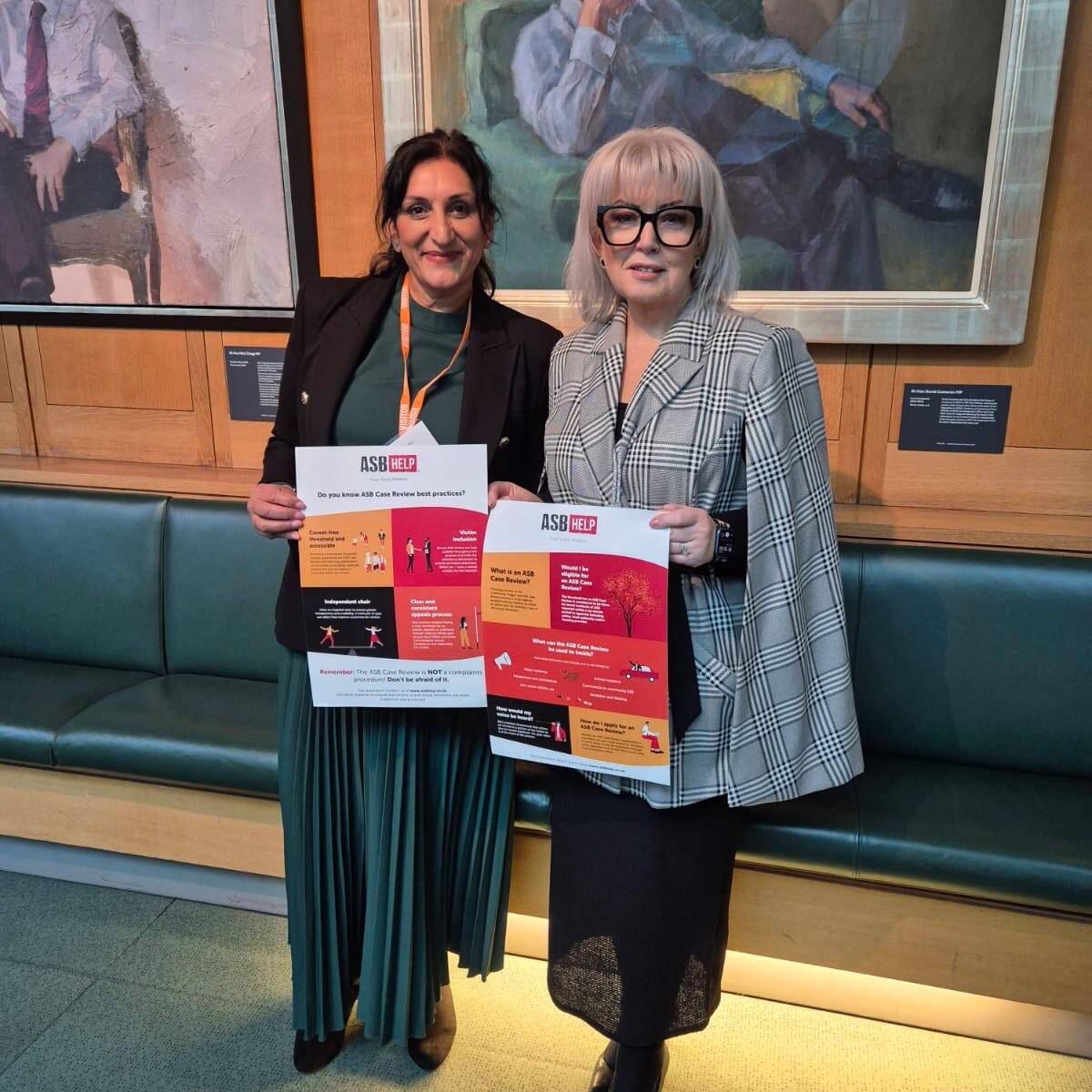ASB Help's CEO with the Victims' Commissioner, holding up an ASB Case Review poster.
